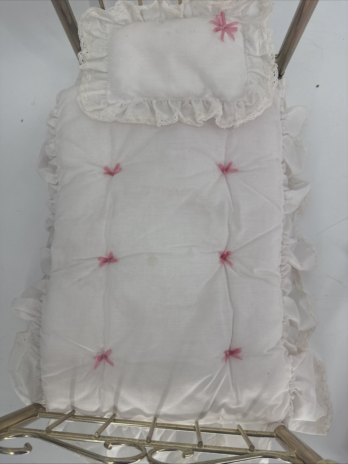 White embroidered fabric with pink flowers on a white background
